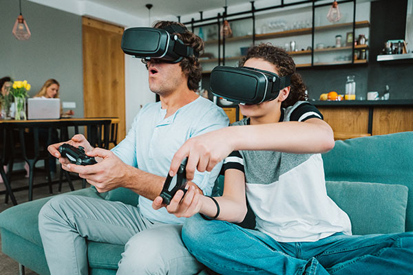 Two people with VR headsets gaming