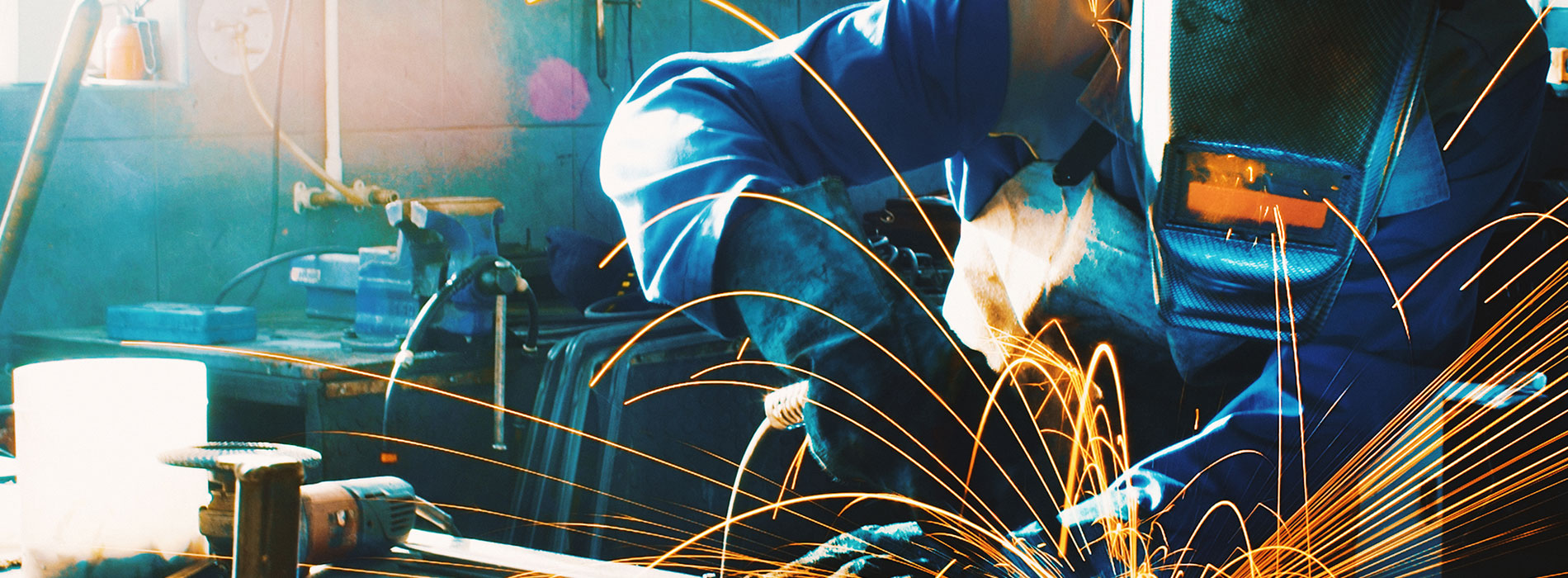 Worker in suit with sparks flying