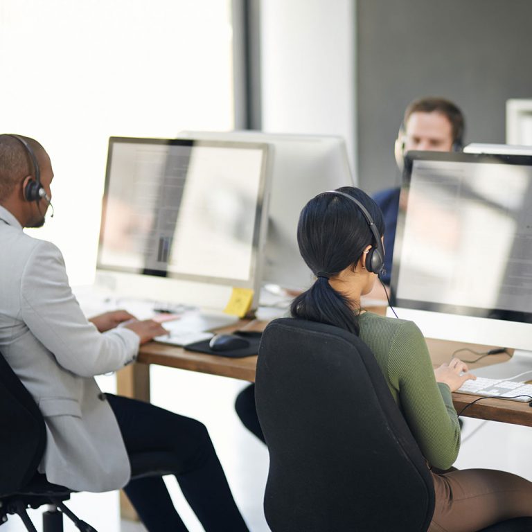 Workings in office with headsets